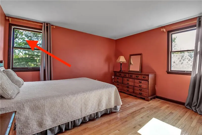 A bedroom with an arrow pointing to the window where the light was first seen