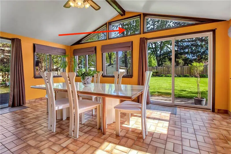 The Florida room with an arrow pointing at the upper windows